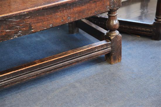 An 18th century oak settle, W.5ft 11in. D.1ft 9.5in. H.3ft 7in.